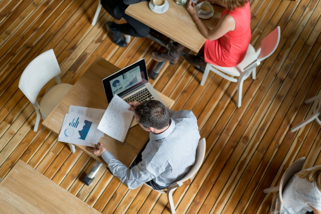 Student Sitting on a chair working looking at budget charts - Financial Tips