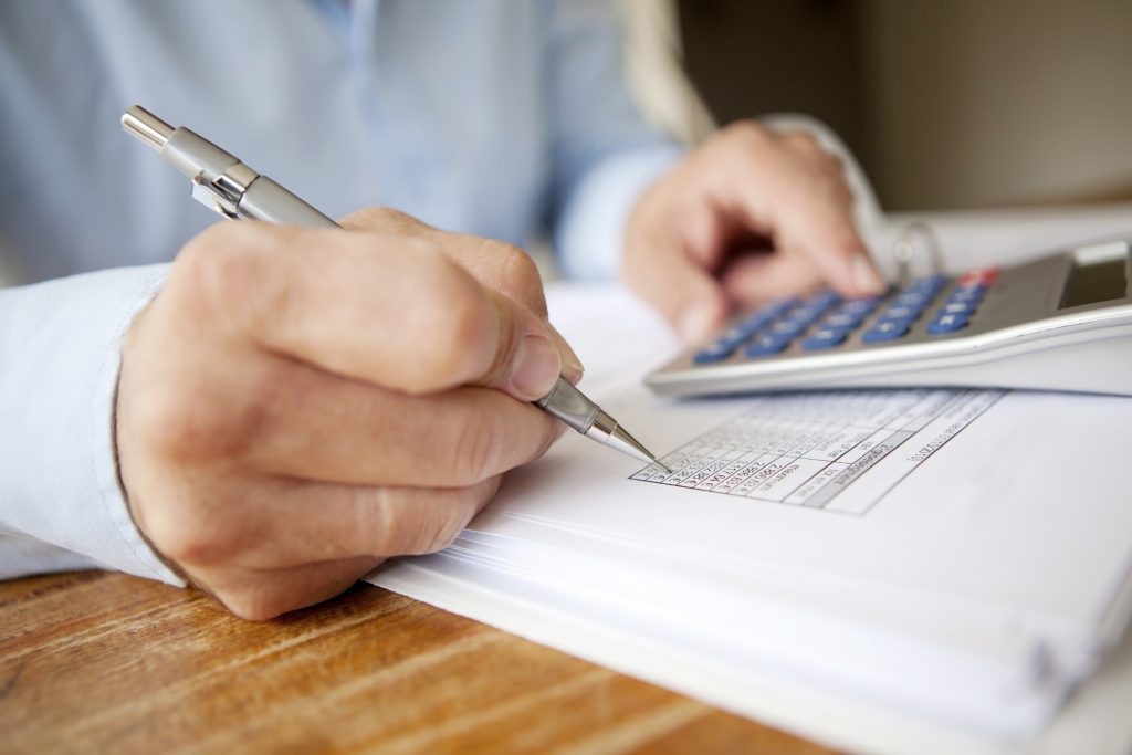 A man calculating his Certificate of Deposit Profits