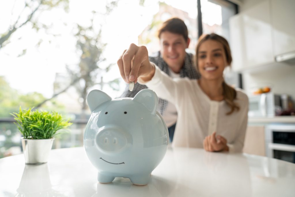 Couple-Saving-Money-In-A-Piggybank | What is savings?