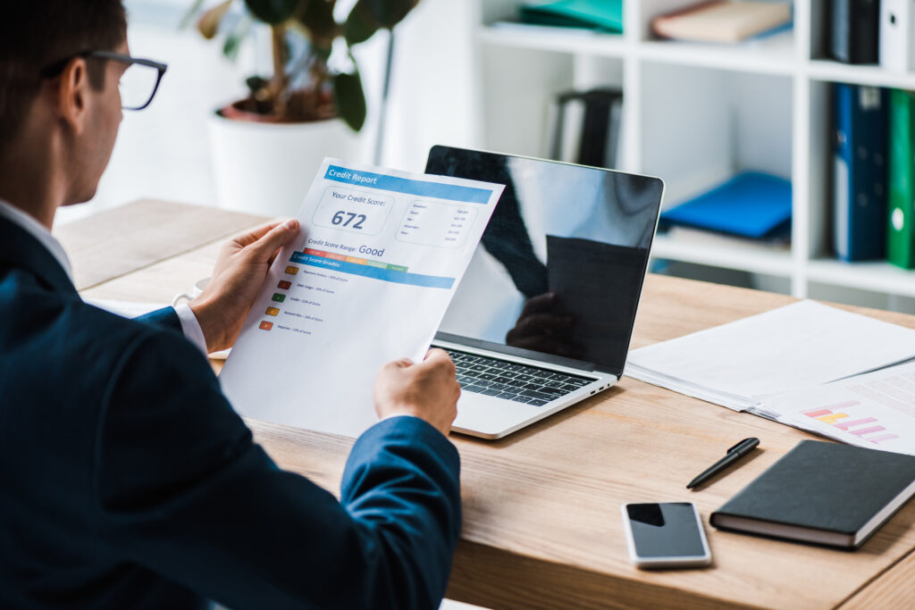 View of Man Holding Paper with Credit Report