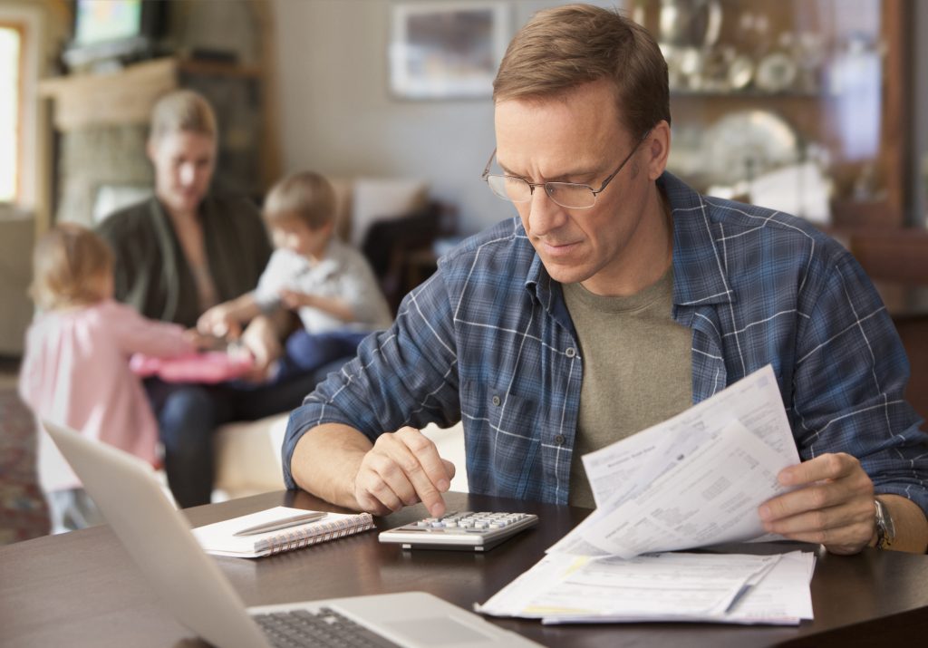 A Man Doing Calculations to Consider Declaring Bankruptcy